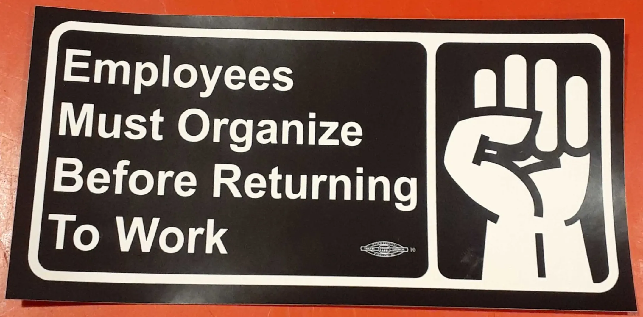 Employees must organize before returning to work sticker in the style of a handwashing reminder sticker with a raised fist instead of hands being washed.
